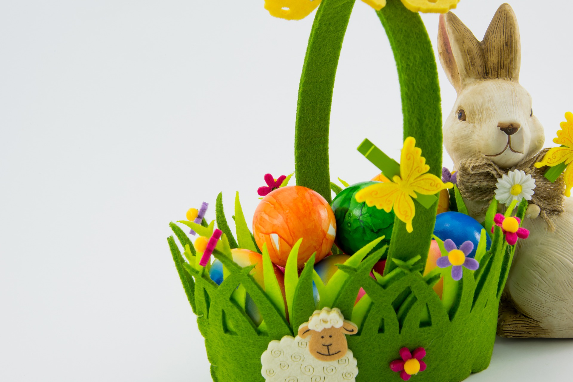 An easter basket decorated with grass and a bunny